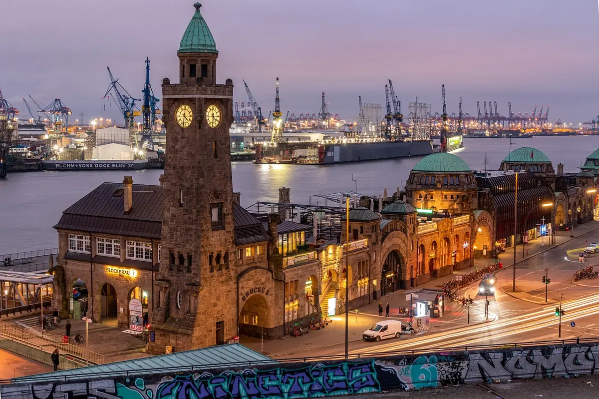 Hamburger Hafen mit Michel-Blick bei Dämmerung — Standort norddeutscher Mittelstandskunden, die bundesweit agieren.