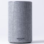 gray jbl portable speaker on white table